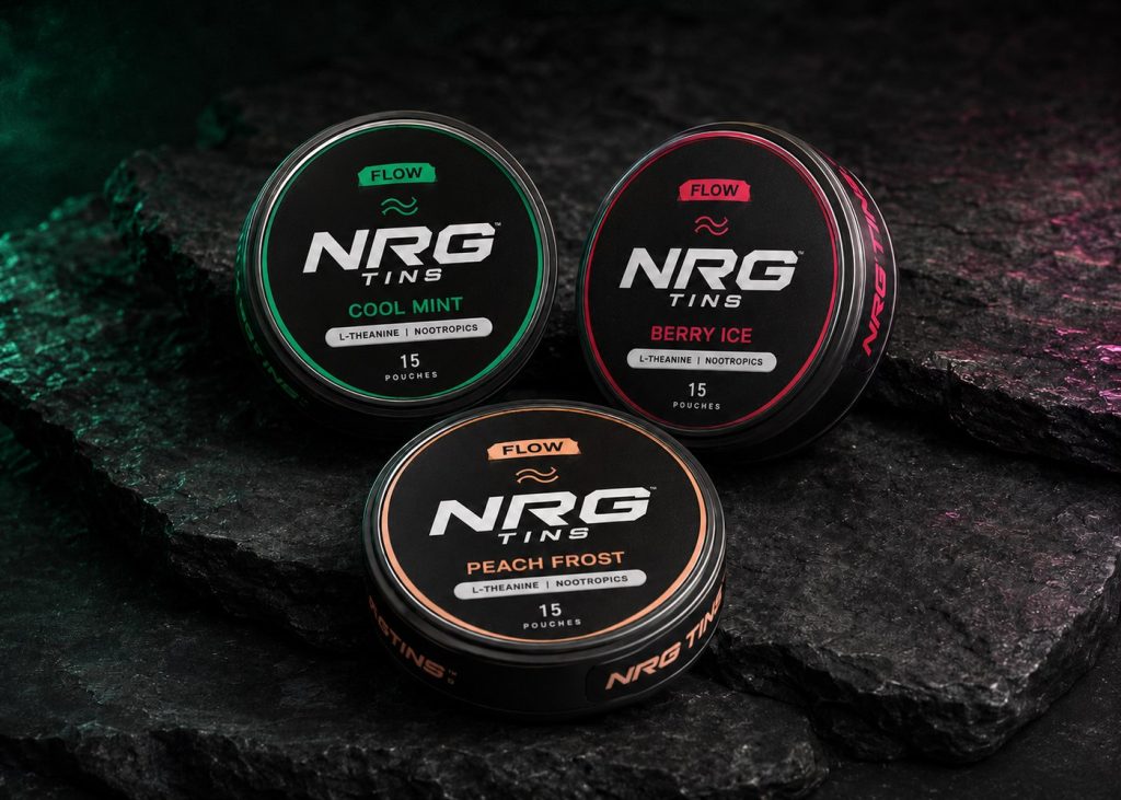 FLOW Cool Mint, Peach Frost and Berry Ice tins on black stone in soft cool light.