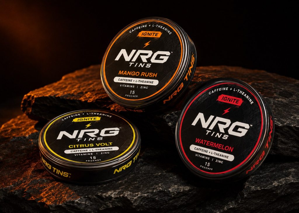 IGNITE Mango Rush, Citrus Volt and Watermelon tins on black stone in warm light.